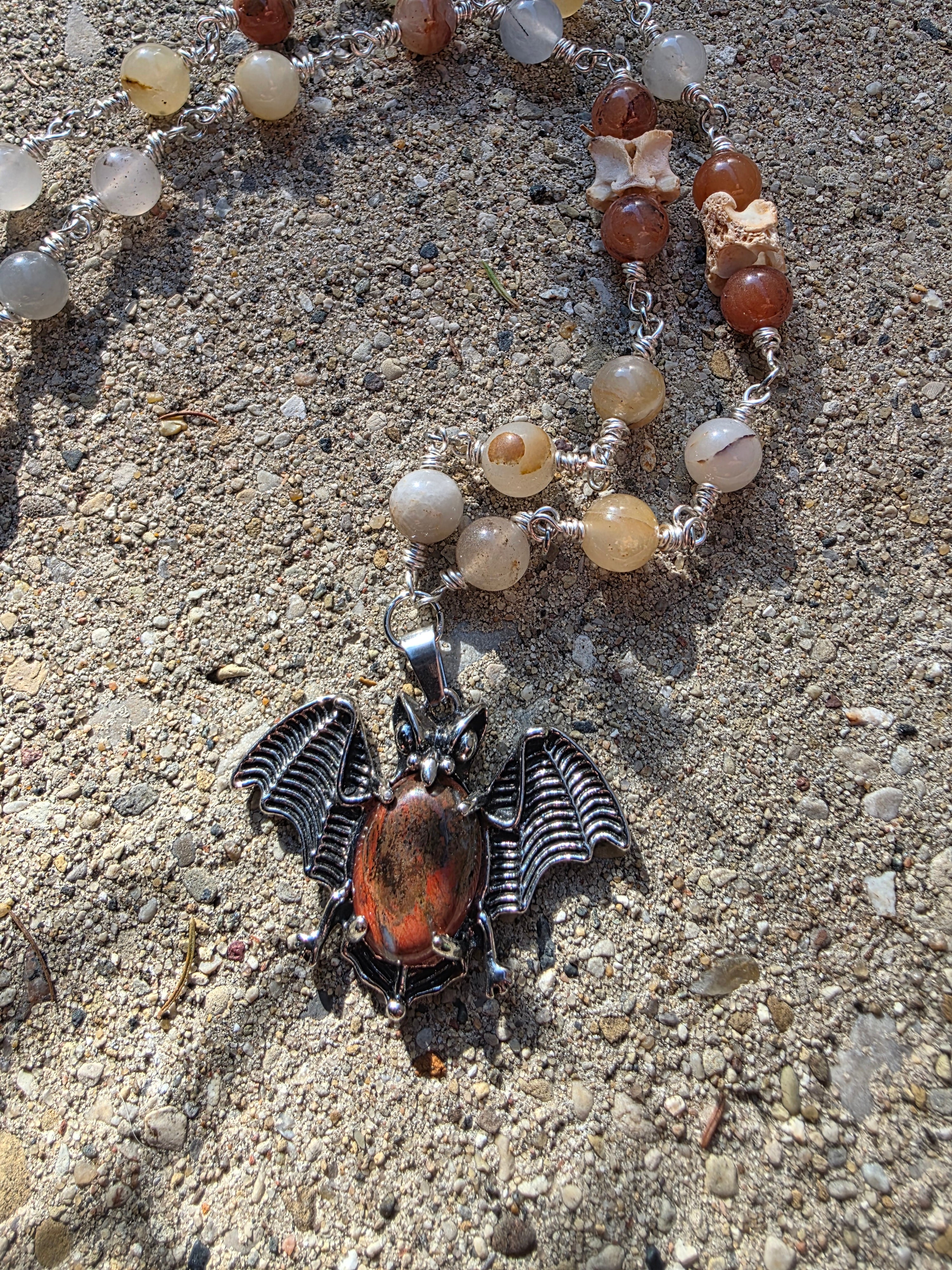 Bat and snake vertebrae necklace